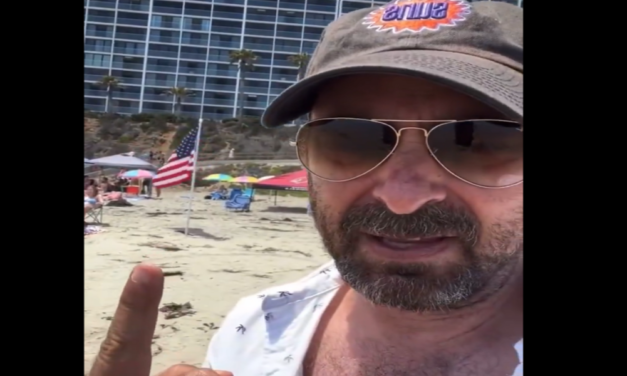 Watch: Liberal dinkus freaks out on the beach, there are too many American flags for him