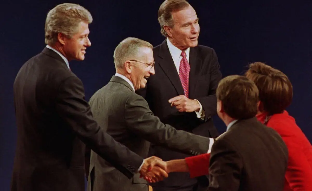 U.S. presidential candidates Bill Clinton (L), Ross Perot (C) and President George Bush (R) shake hands with the panelists after the conclusion of their final debate on Oct. 19, 1992. (J. David Ake/AFP via Getty Images)
