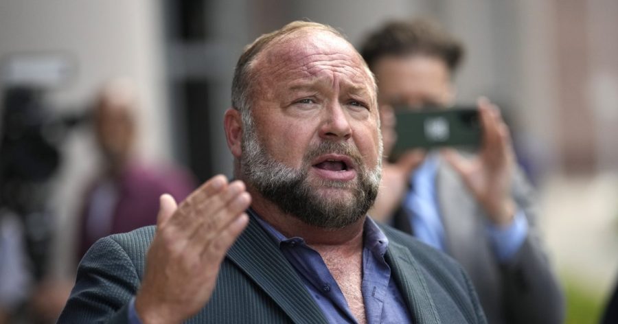 Alex Jones speaks to the media after arriving at the federal courthouse for a hearing in front of a bankruptcy judge, June 14, 2024, in Houston. A U.S. bankruptcy court trustee is planning to shut down Jones' Infowars media platform and liquidate its assets to help pay the $1.5 billion in lawsuit judgments Jones owes for repeatedly calling the 2012 Sandy Hook Elementary School shooting a hoax. (AP Photo/David J. Phillip, file)