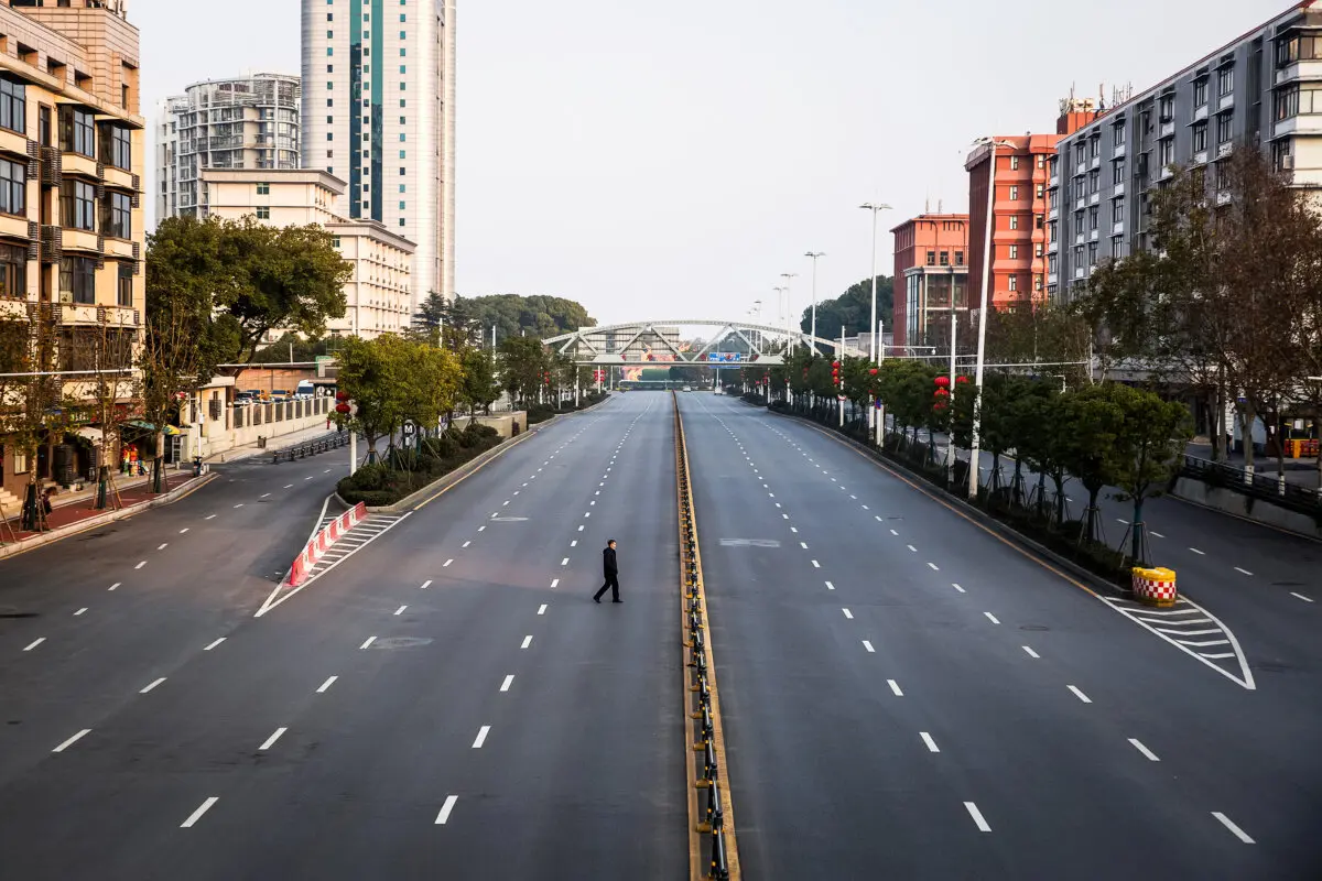 A man crosses an empty highway in Wuhan, Hubei Province, China, on Feb. 3, 2020. (Getty Images)