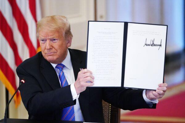 President Donald Trump holds an executive order he signed at the White House in Washington, on June 26, 2020. (Mandel Ngan/AFP via Getty Images)
