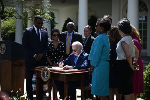 President Joe Biden (C) signs an executive order in the Rose Garden of the White House, on April 21, 2023. (Brendan Smialowski/AFP via Getty Images)
