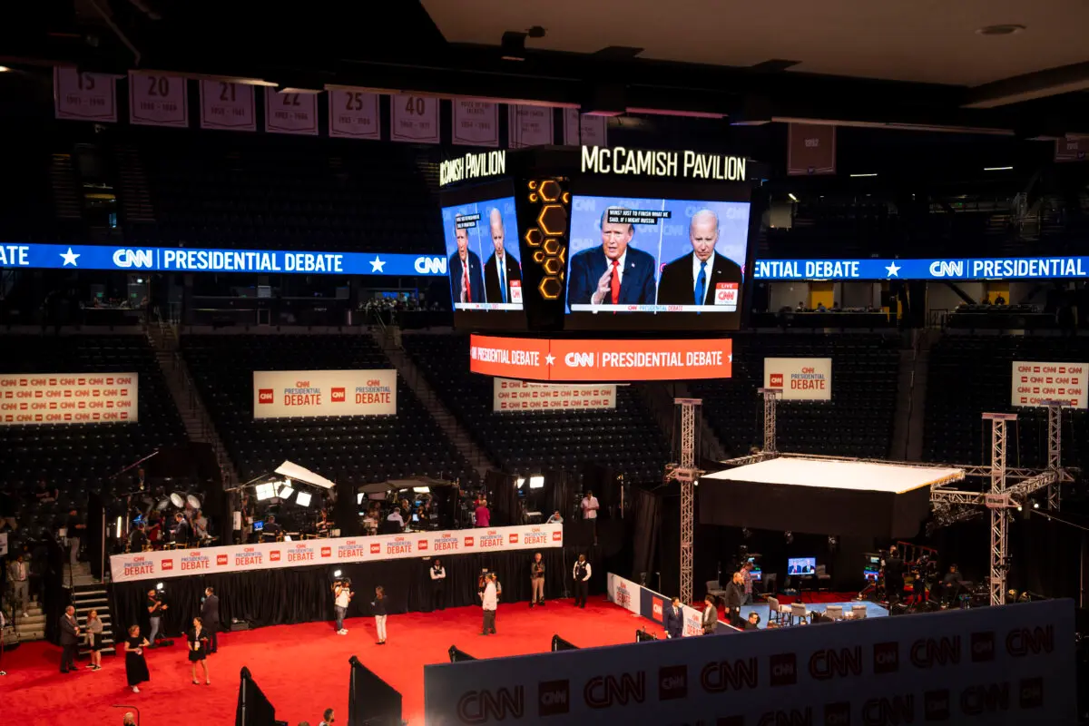 Former President Donald J. Trump and President Joe Biden through a screen from the spin room during the presidential debate in Atlanta, Ga., on June 27, 2024. (Madalina Vasiliu/The Epoch Times)