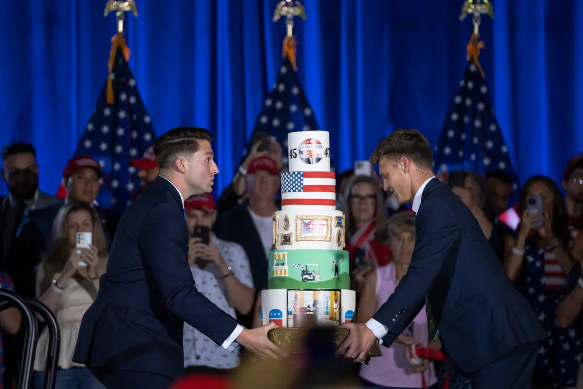 Campaign staff brings to stage a cake for former President Donald J. Trump’s 78th birthday party event at the Palm Beach County Convention Center in West Palm Beach, Fla., on June 14, 2024. (Madalina Vasiliu/The Epoch Times)