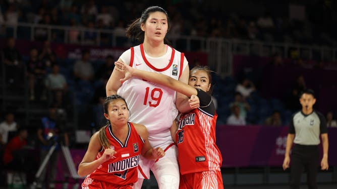 Zhang Ziyu, a 17-year-old Chinese basketball player, stands 7'2