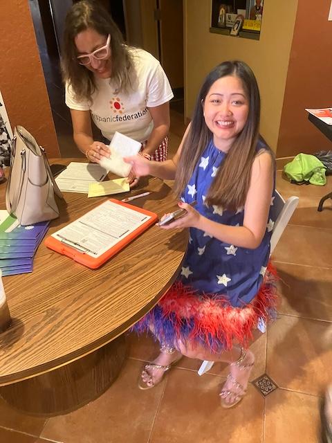 Registered nurse Maya Green, a native of Thailand, registers to vote after reciting the citizen’s oath at naturalization ceremony at Hope CommUnity Center in Apopka, Florida, on July 4, 2024. (Epoch Times/John Haughey)