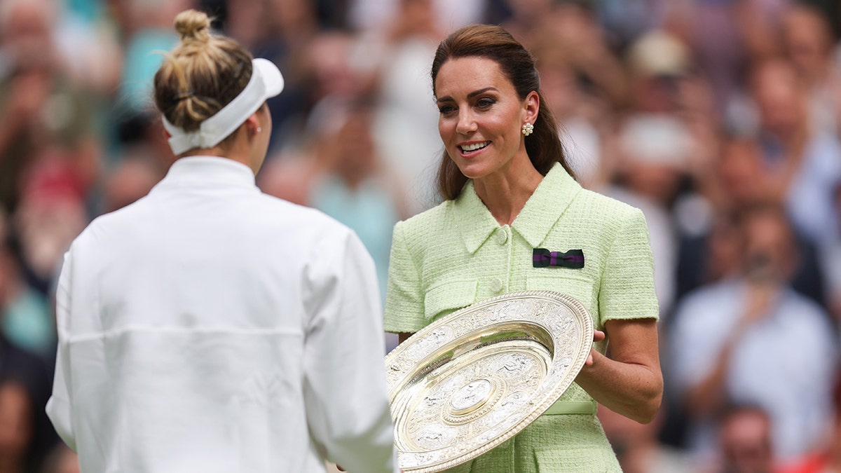 Kate Middleton in a light green dress presents the Venus Rosewater Dish tropy to Marketa Vondrousova at Wimbledon 2023
