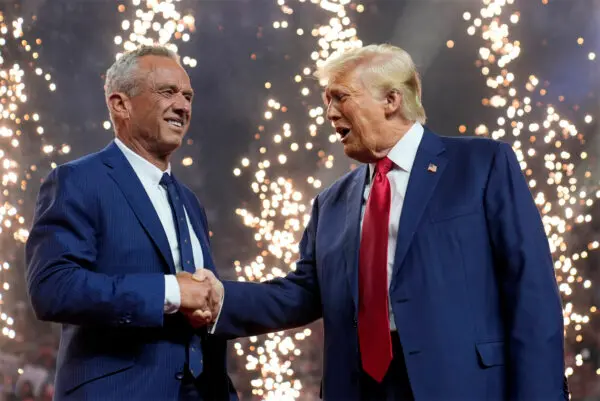 Republican presidential nominee former President Donald Trump shakes hands with Independent presidential candidate Robert F. Kennedy Jr. at a campaign rally at the Desert Diamond Arena in Glendale, Ariz., on Aug. 23, 2024. (Evan Vucci/AP Photo)