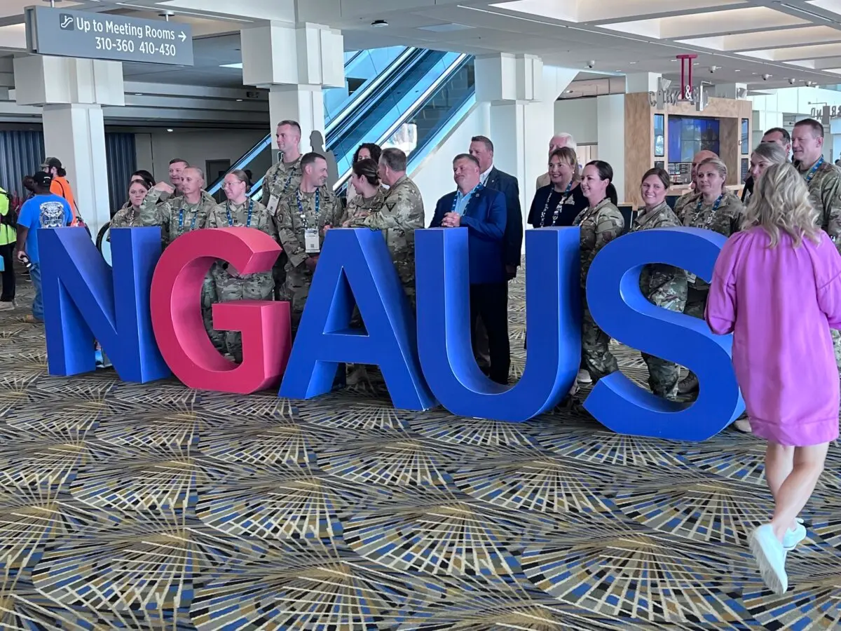 Members of the National Guard Association of the United States prepare for a group photo at their convention in Detroit, Mich., on Aug. 26. 2024. (Lawrence Wilson/The Epoch Times)