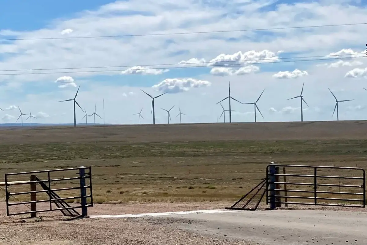 Wind turbines sprawl across a valley west of the Medicine Bow Range in Wyoming. (John Haughey/The Epoch Times)