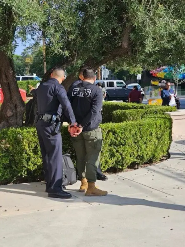 A man is taken into police custody outside an event attended by Democratic presidential candidate Robert F. Kennedy Jr, at Wilshire Ebell Theatre in Los Angeles, Calif., on Sept. 15, 2023. (Courtesy of Stefanie Spear)