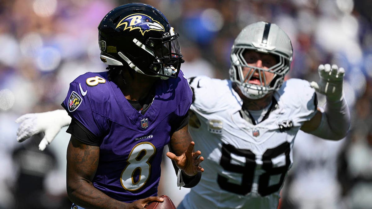 Lamar Jackson being chased down by Maxx Crosby