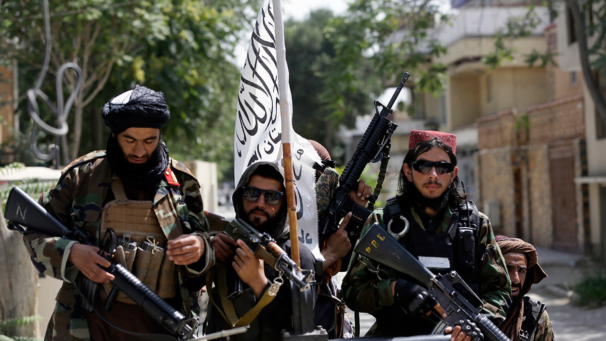 Taliban fighters display their flag on patrol in Kabul, Afghanistan, on Thursday, Aug. 19, 2021.