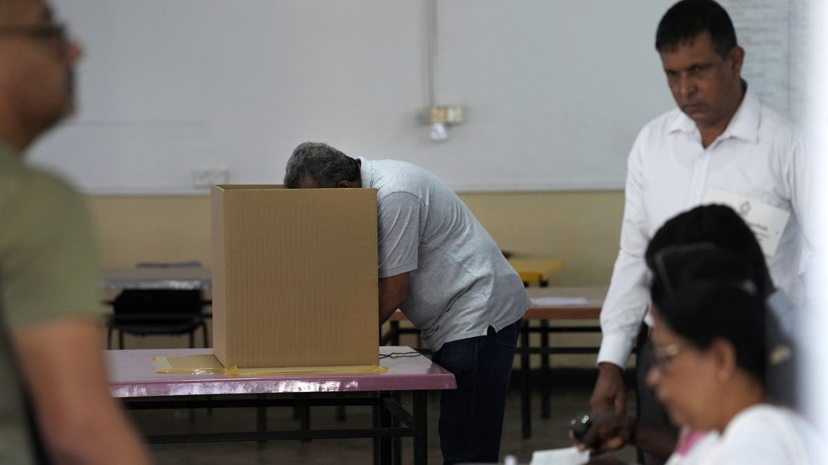 A man casts his vote at a polling station in Colombo, Sri Lanka, Saturday, Sept. 21, 2024. 