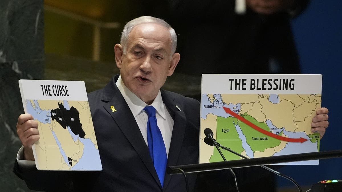 Prime Minister of Israel Benjamin Netanyahu holds signs as he addresses the 79th session of the United Nations General Assembly on Friday, Sept. 27, 2024.