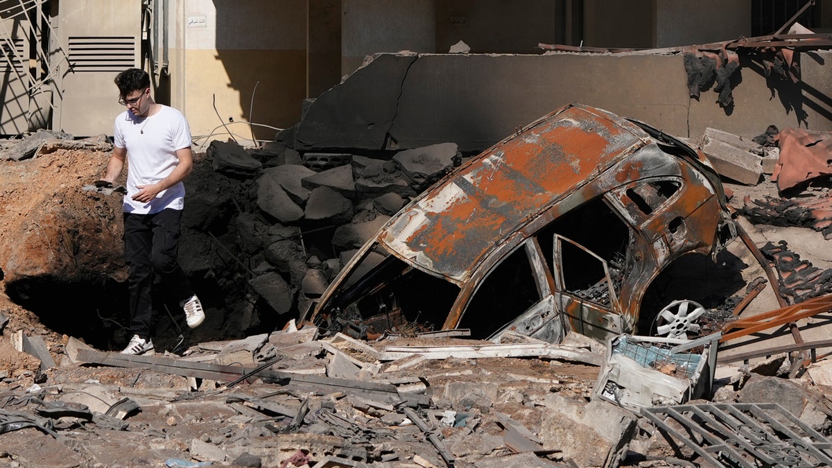 Man standing near rubble