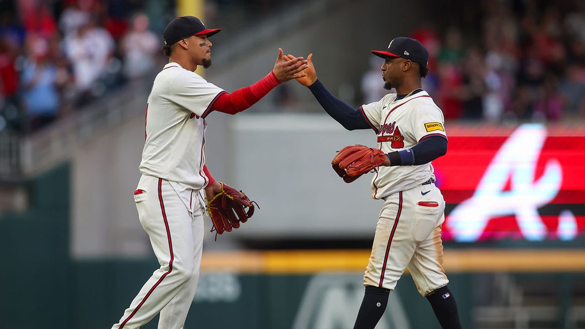 Orlando Arcia and Ozzie Albies high five