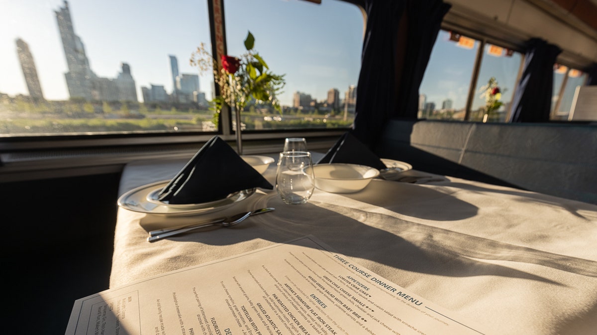 The Amtrak dining car with a city outside the window.