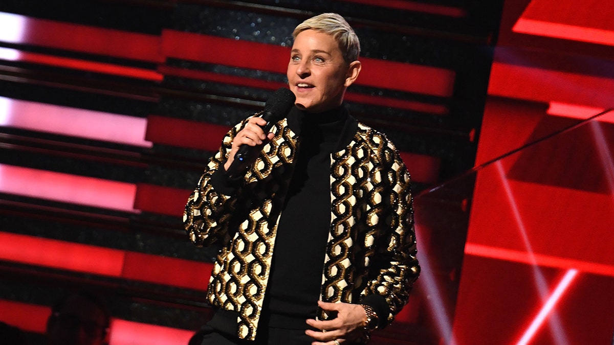 Ellen DeGeneres on stage with microphone in her hand