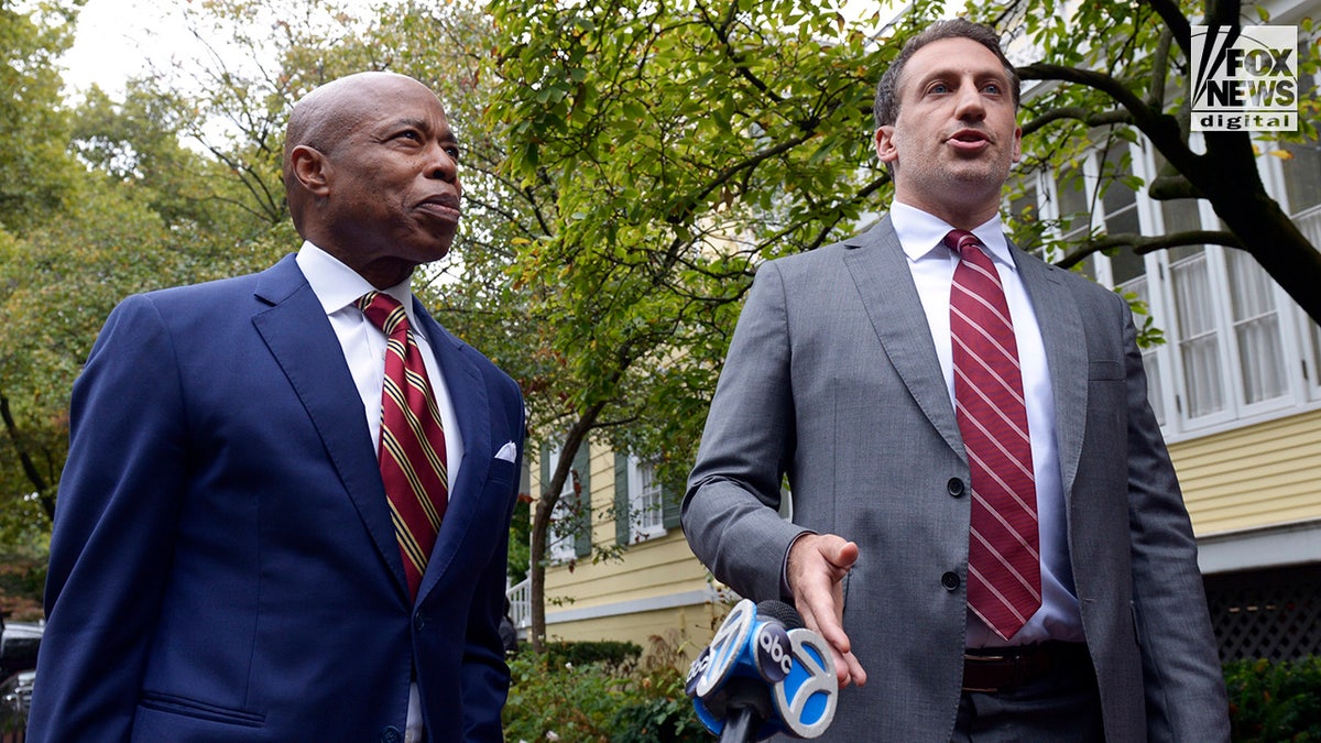 New York City Mayor Eric Adams and attorney Alex Spiro speak to the press outside of Gracie Mansion