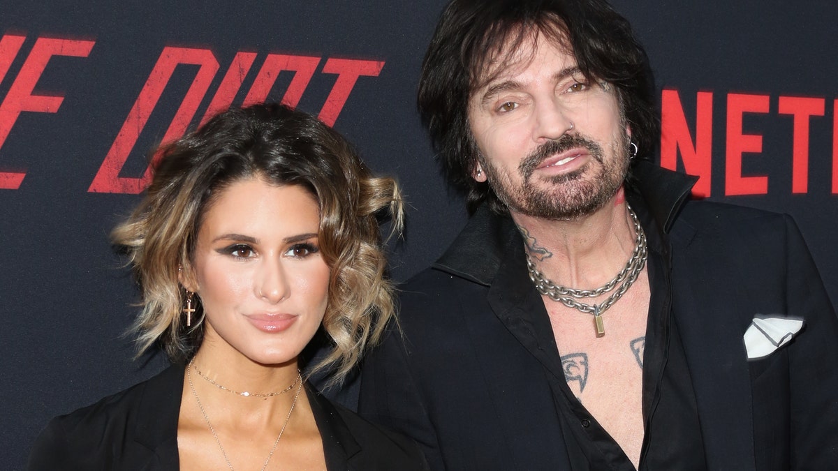 Brittany Furlan and Tommy Lee looking serious at the red carpet premiere of his movie 