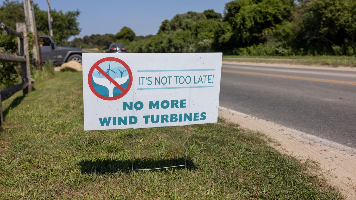 anti-wind turbine sign on roadside