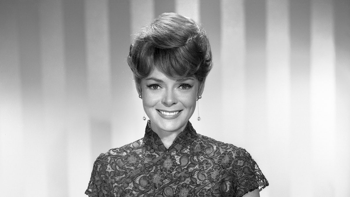 A black and white close-up of June Lockhart smiling