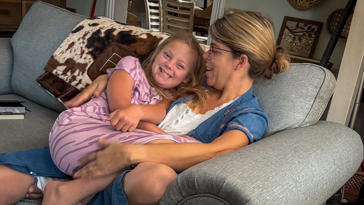 Indiana Feek on Rory Feek's wife Rebecca's lap