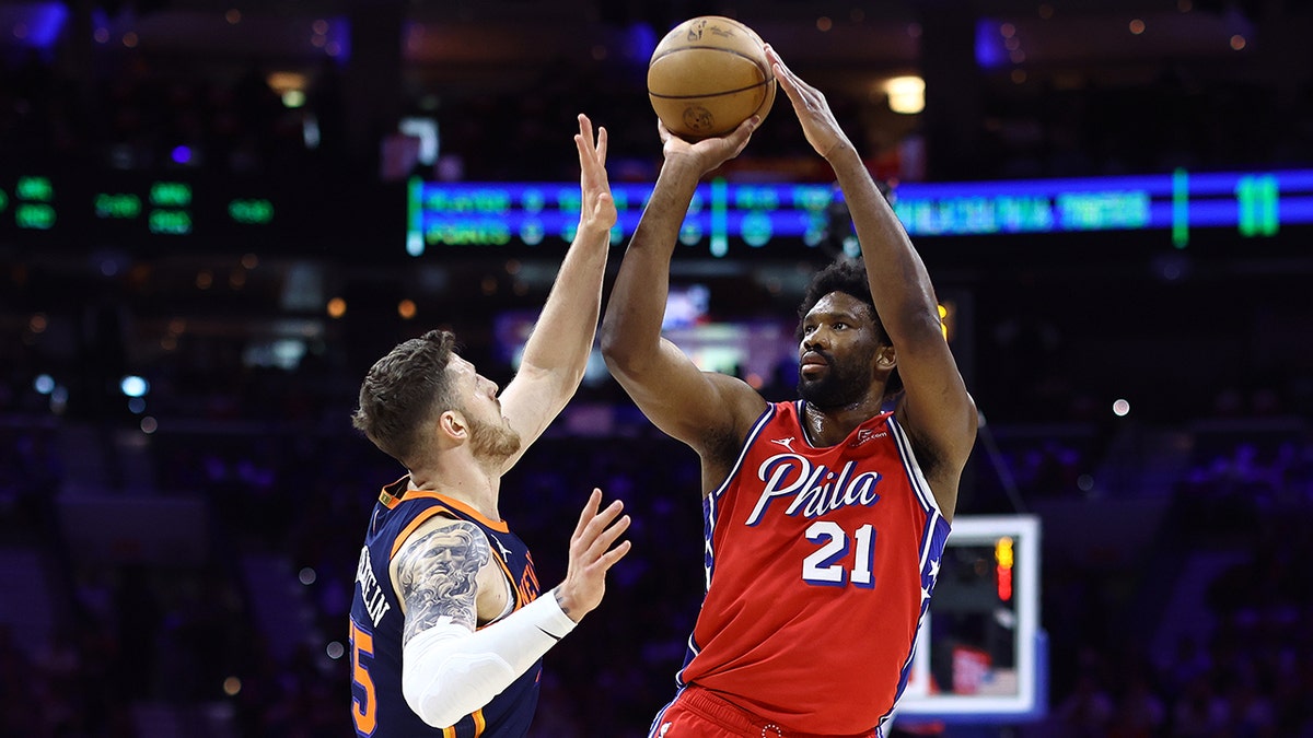 Joel Embiid shoots basketball