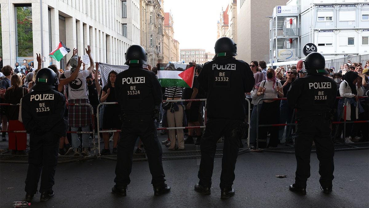 German police stand in front of pro-Palestinian protesters in front of Humboldt University in Berlin.