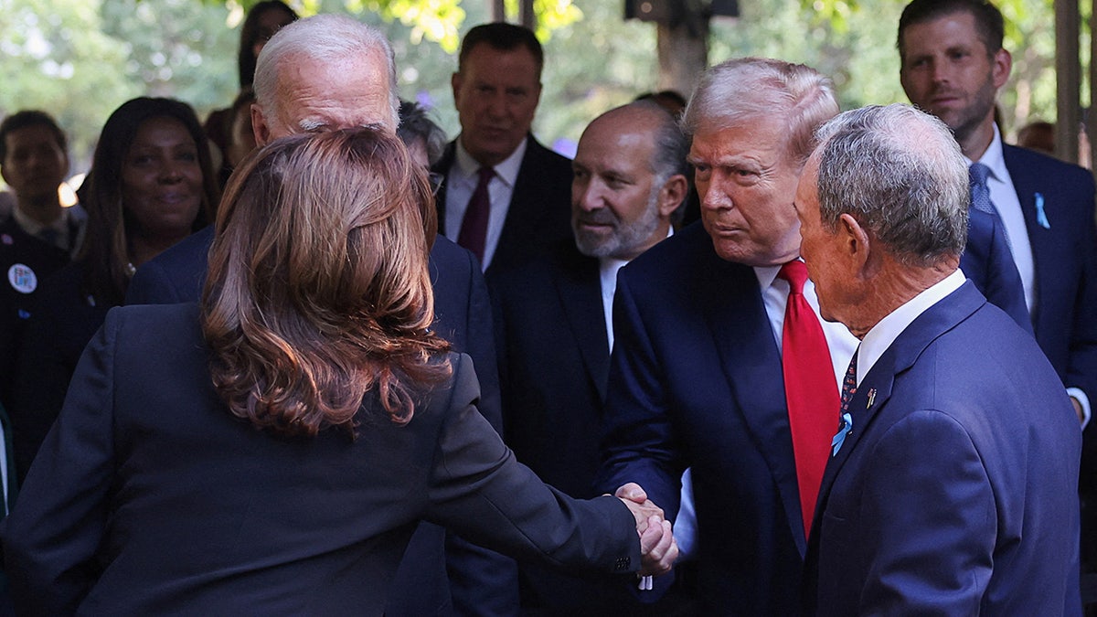 Republican presidential nominee and former U.S. President Donald Trump shakes hands with Democratic presidential nominee and Vice President Kamala Harris on the day of a ceremony marking the 23rd anniversary of the September 11, 2001 attacks on the World Trade Center