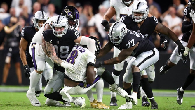 Baltimore Ravens QB Lamar Jackson is sacked by Raiders DE Maxx Crosby at Allegiant Stadium in Las Vegas. (Mark J. Rebilas-Imagn Images)