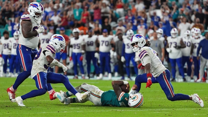 Miami Dolphins QB Tua Tagovailoa lays on the ground concussed after being tackled by Buffalo Bills safety Damar Hamlin at Hard Rock Stadium. (Jasen Vinlove-Imagn Images)