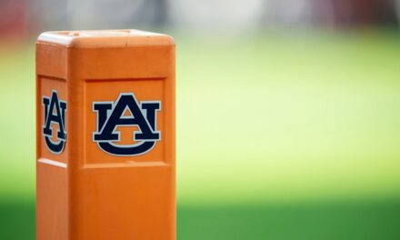 Auburn cheerleader knocks down Oklahoma player running onto field while performing stunts