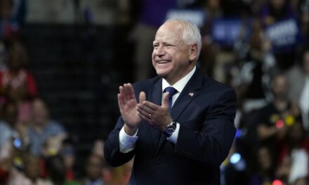 Weird: Tim Walz Gives a Jazz Hands Welcome as He Deplanes