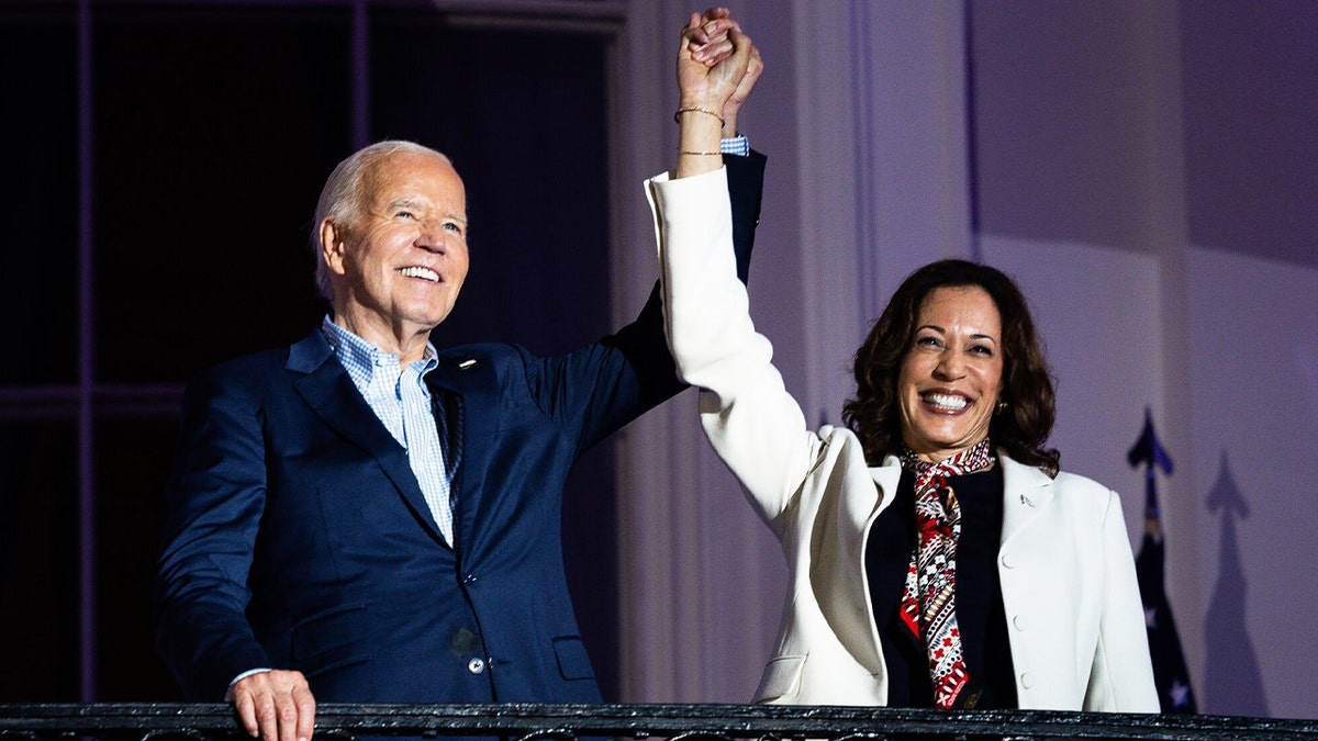 Biden and Harris with arms raised