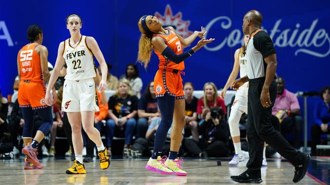 Connecticut Sun guard DiJonai Carrington mocks Indiana Fever guard Caitlin Clark after committing a foul against the rookie star.