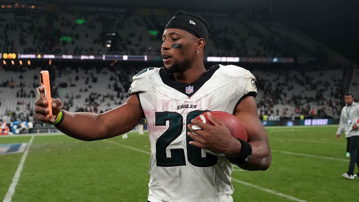 Saquon Barkley holds up cell phone