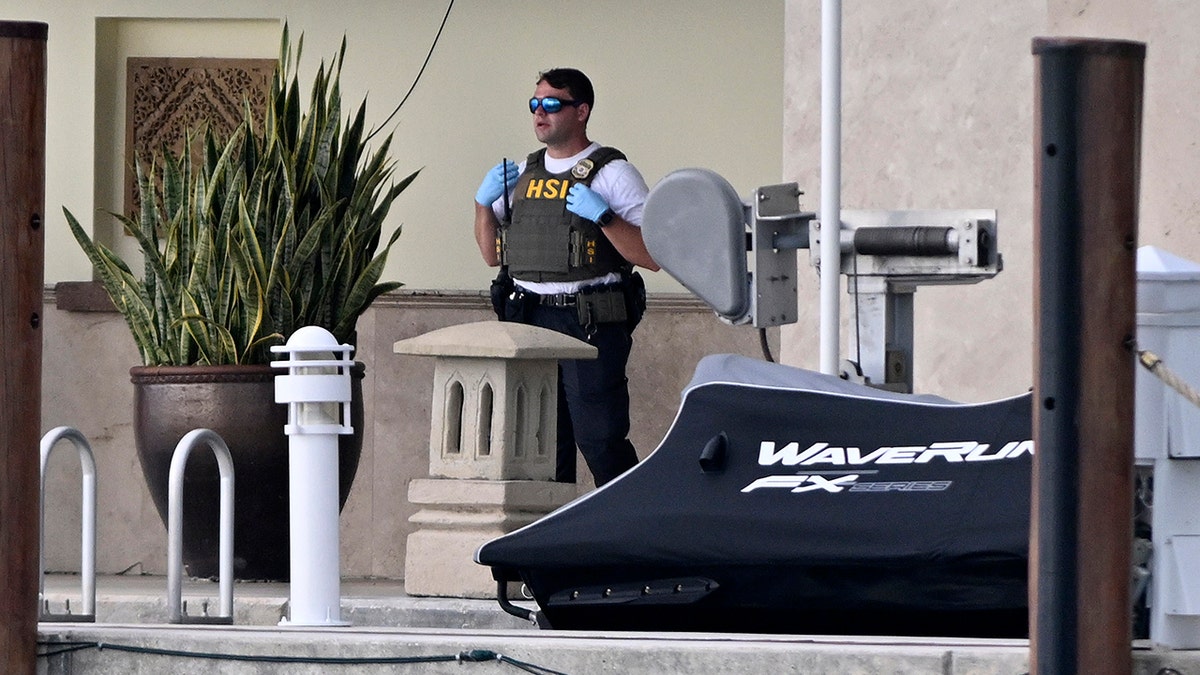 An agent stands on Diddy's boardwalk looking serious