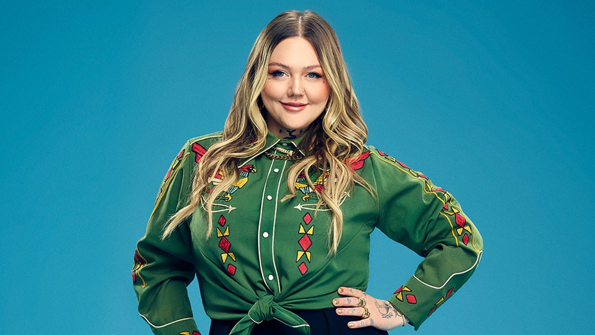 Elle King poses in green blouse