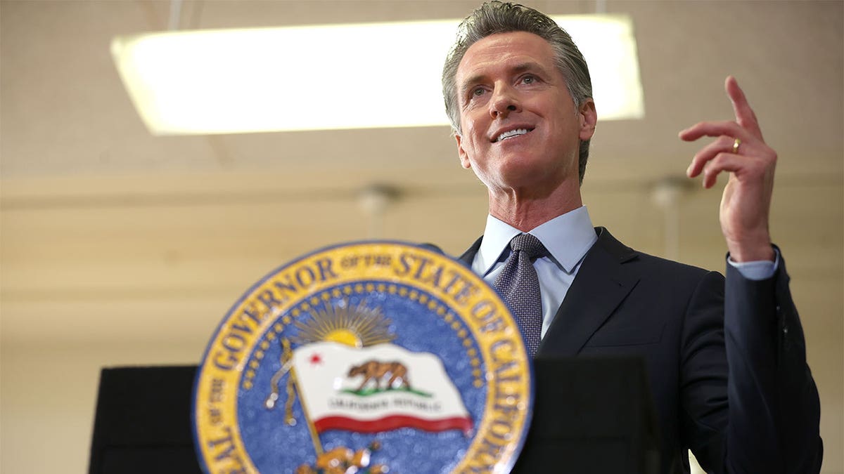 Gaving Newsom at podium with state seal