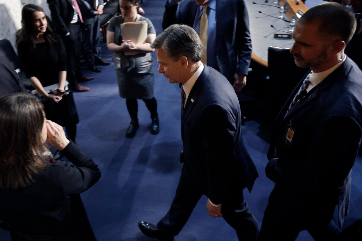 FBI Director Christopher Wray (C) heads into a closed session of the Senate Select Committee on Intelligence in Washington on March 11, 2024 (Chip Somodevilla/Getty Images)