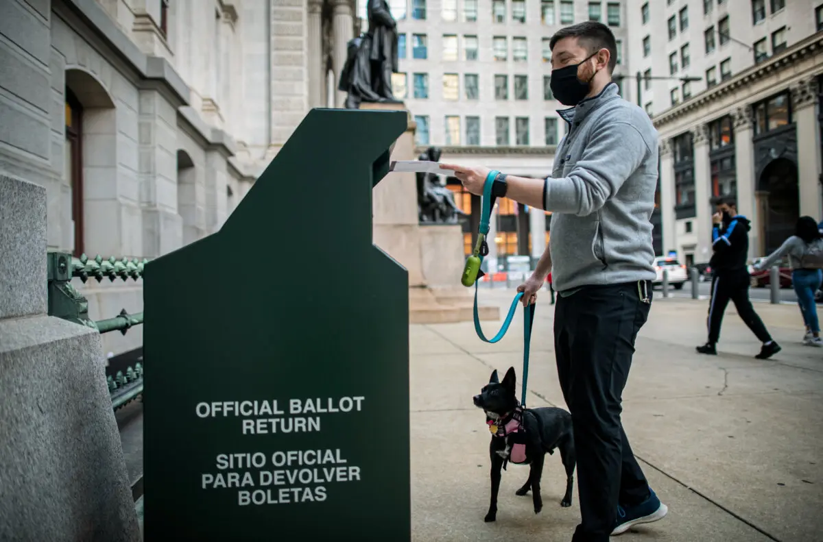 A voter casts his early ballot at a drop box outside of City Hall on Oct. 17, 2020, in Philadelphia, Pennsylvania. (Mark Makela/Getty Images)