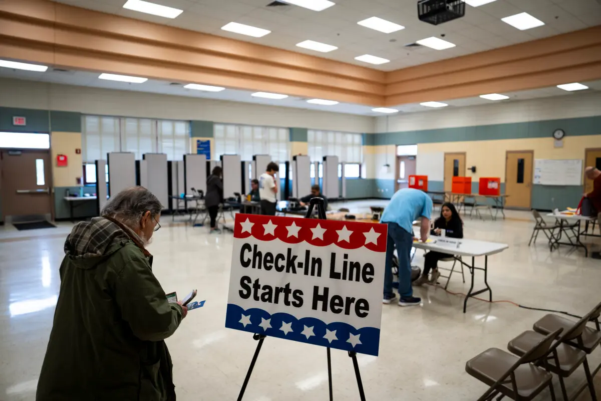 A voter waits in the check-in line at a voting site during the primary election in Elkridge, Md., on May 14, 2024. (Madalina Vasiliu/The Epoch Times)