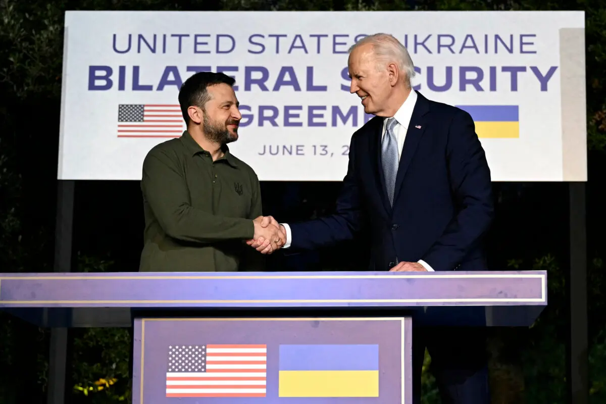 U.S. President Joe Biden and Ukrainian President Volodymyr Zelenskyy (L) shake hands after signing a bilateral security agreement on the sidelines of the G7 Summit hosted by Italy in the Apulia region on June 13, 2024. (Mandel Ngan/AFP via Getty Images)