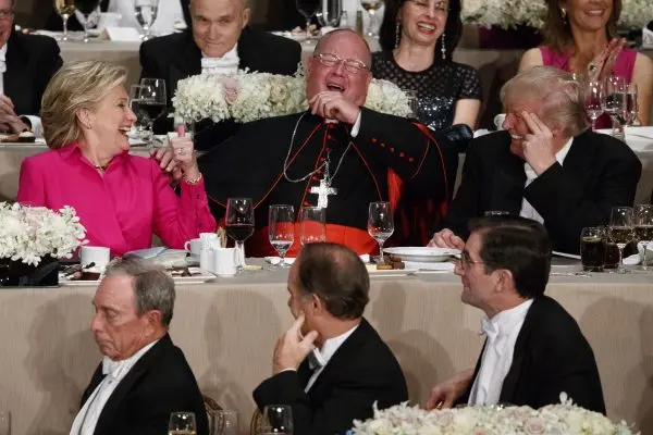 Republican presidential candidate Donald Trump (R), Cardinal Timothy Dolan, Archbishop of New York (C), and Democratic presidential candidate Hillary Clinton during the Alfred E. Smith Memorial Foundation dinner, in New York, on Oct. 20, 2016. (AP Photo/ Evan Vucci)