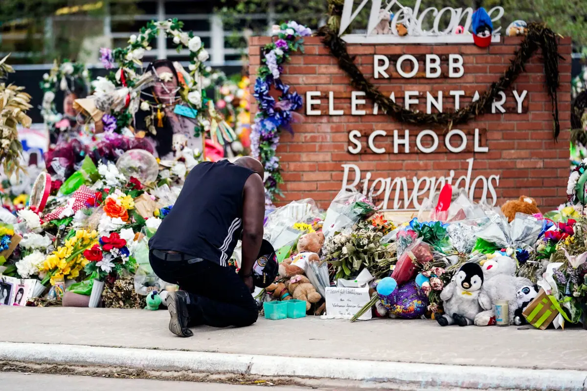 A man pays his respects at a memorial at Robb Elementary School in Uvalde, Texas, on June 9, 2022. (Eric Gay, File/AP Photo)