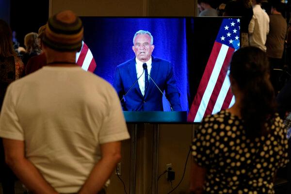 People watch on a monitor as Independent presidential candidate Robert F. Kennedy Jr. announces he is suspending his presidential campaign at a news conference on Aug 23, 2024, in Phoenix. (AP Photo/Darryl Webb)