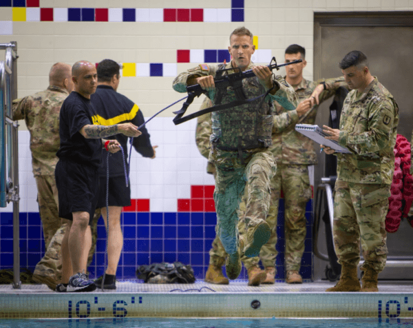 Staff Sgt. Daniel Abbott, a horizontal construction engineer with the Virginia Army National Guard, begins the Army National Guard Best Warrior Competition's Water Survival Test at Joint Base Elmendorf-Richardson, Alaska, on July 7, 2023. (Robert DeBerry/Alaska National Guard)