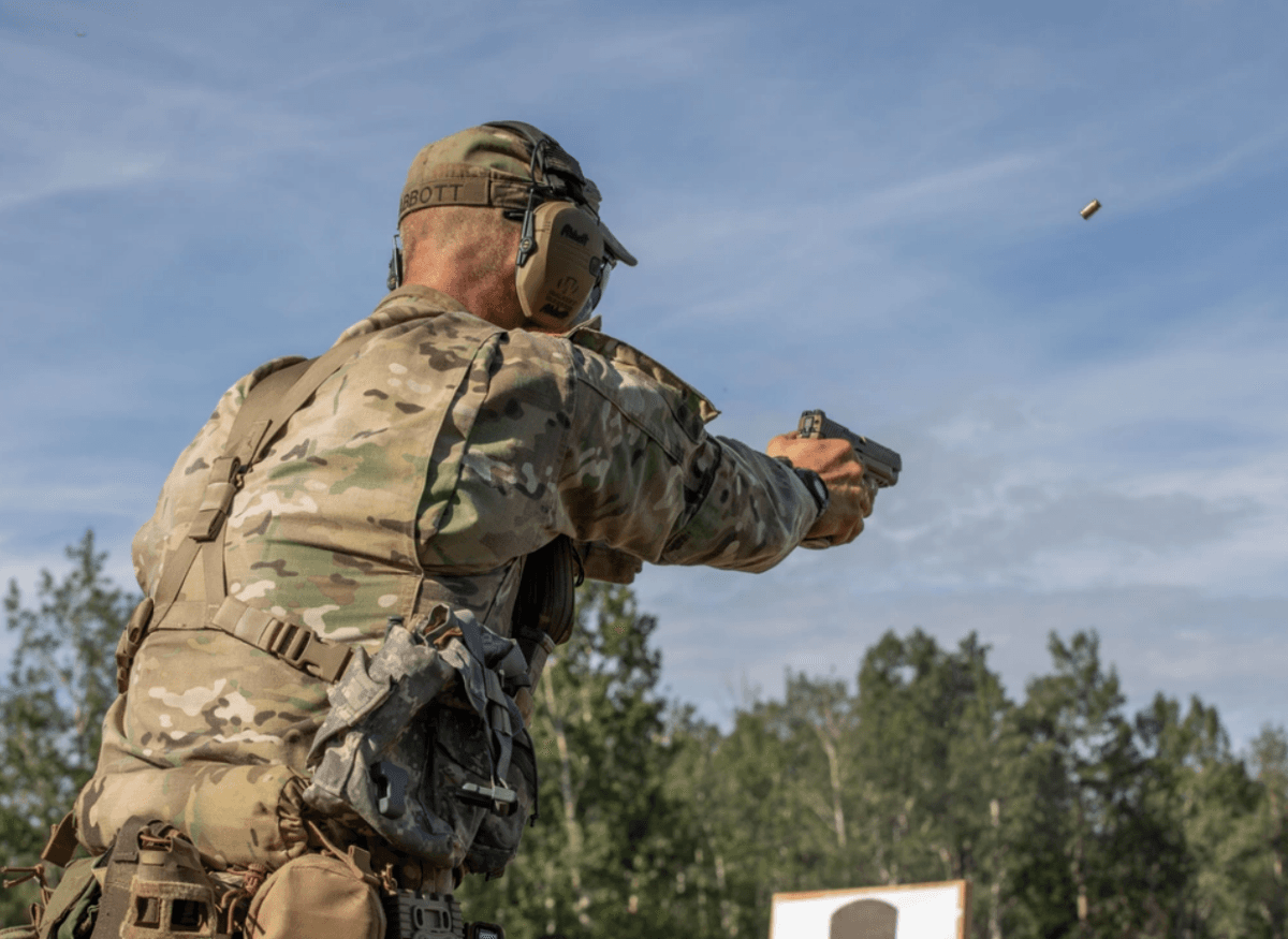 Staff Sgt. Daniel Abbott, a horizontal construction engineer with the Virginia Army National Guard, fires an M17 pistol during the 2023 Army National Guard Best Warrior Competition at Fort Greely, Alaska, on July 11, 2023. (U.S. Army photo by Sgt. Kinsey Geer)